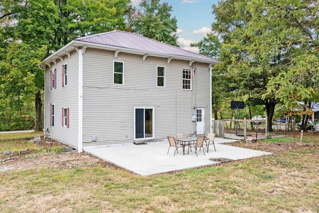 rear view of property featuring a yard and a patio