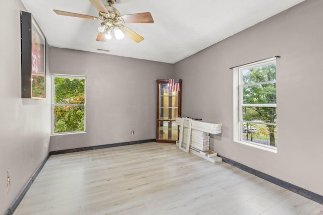 empty room featuring ceiling fan and light hardwood / wood-style floors