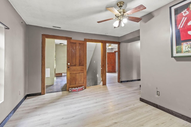 spare room featuring ceiling fan and light wood-type flooring