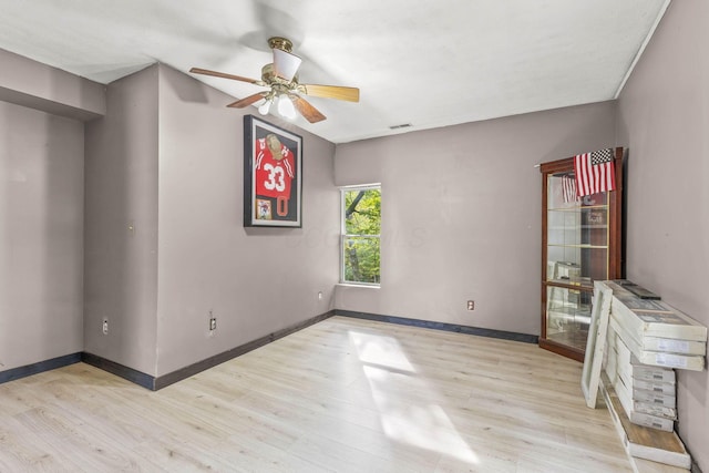 spare room featuring ceiling fan and light wood-type flooring