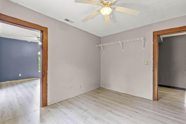 spare room featuring light hardwood / wood-style flooring and ceiling fan