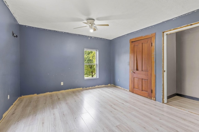 unfurnished bedroom featuring light wood-type flooring and ceiling fan