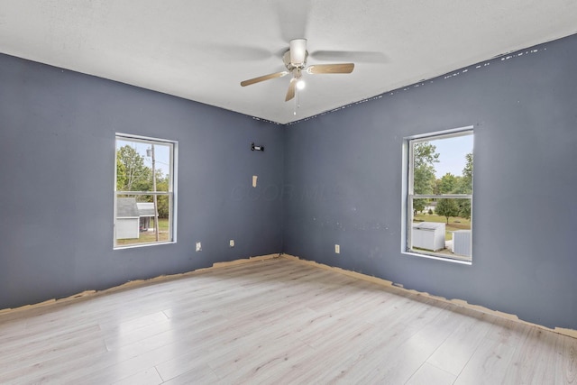 unfurnished room with ceiling fan and light hardwood / wood-style flooring