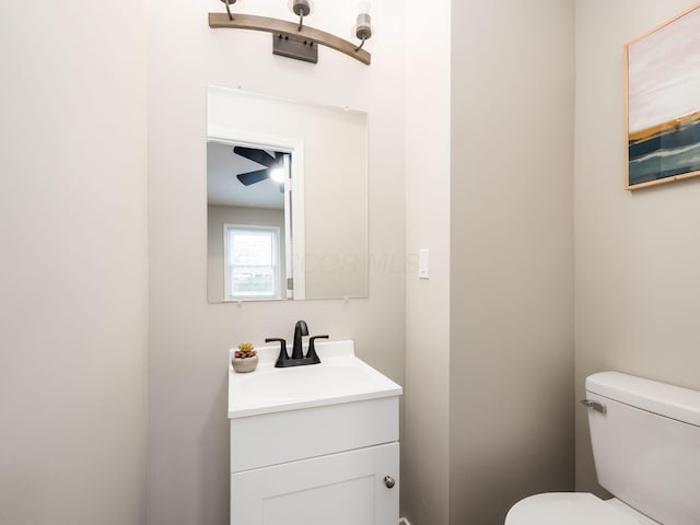 bathroom with vanity, ceiling fan, and toilet