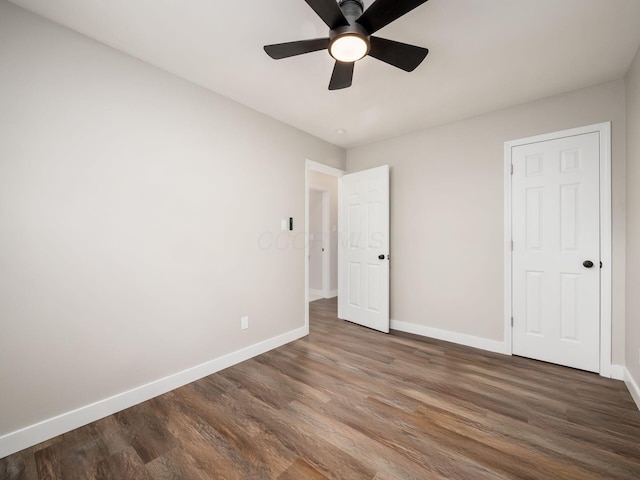 unfurnished bedroom with ceiling fan and dark hardwood / wood-style floors