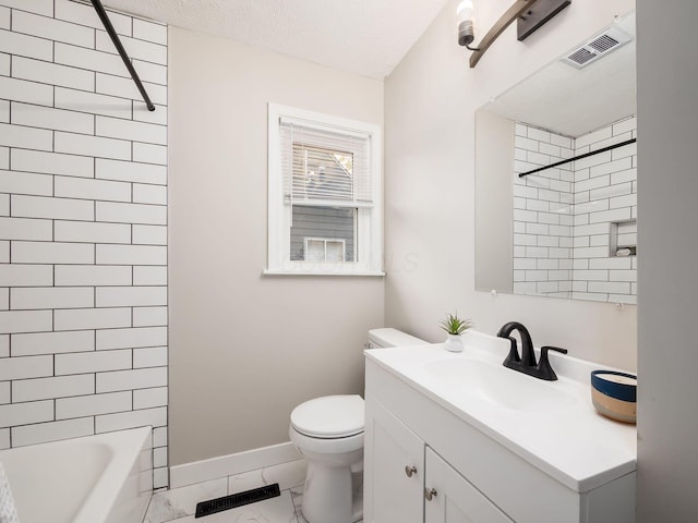 full bathroom with a textured ceiling, vanity, toilet, and tiled shower / bath combo