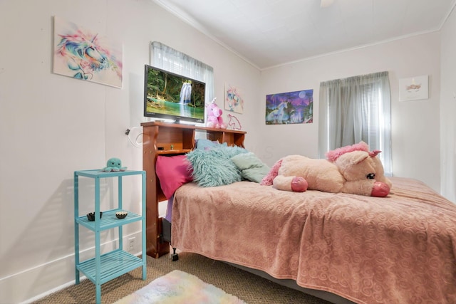 carpeted bedroom with ornamental molding