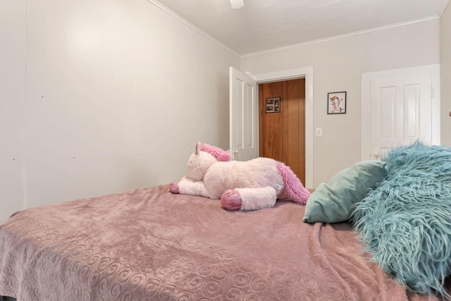 bedroom with a ceiling fan and crown molding