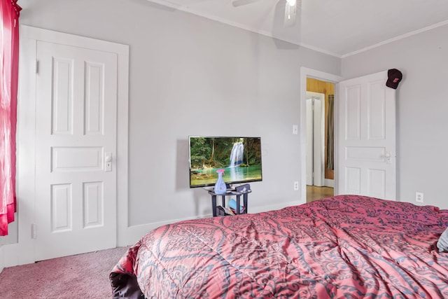 carpeted bedroom with ceiling fan and ornamental molding