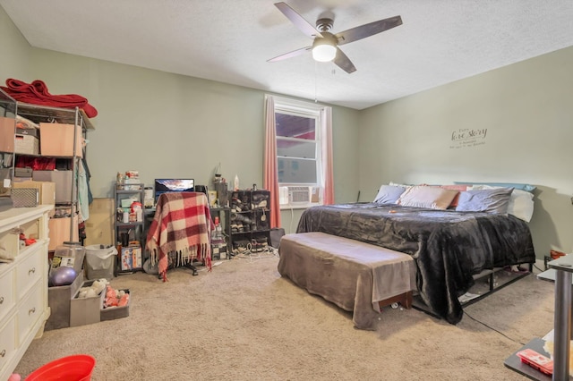 bedroom with a textured ceiling, a ceiling fan, and light colored carpet