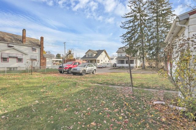 view of yard with a residential view and fence