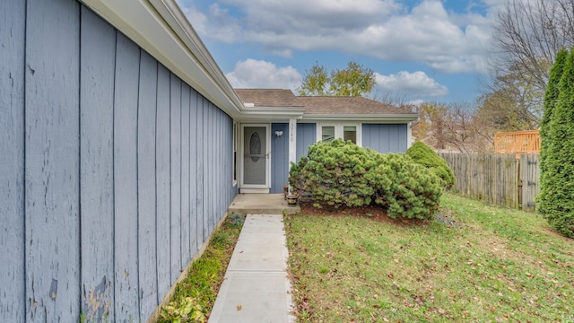 entrance to property with a lawn