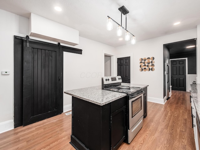 1327 Atcheson St, Columbus, OH 43203 - kitchen with electric range, dark cabinetry, freestanding refrigerator, light wood-style floors, and recessed lighting