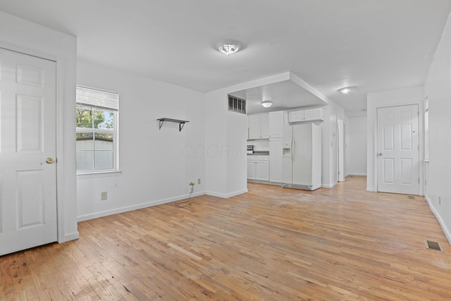 unfurnished living room with light wood-type flooring