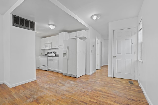 kitchen with white cabinets, white appliances, and light hardwood / wood-style flooring