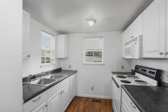 kitchen featuring white cabinetry, sink, dark wood-type flooring, and white appliances