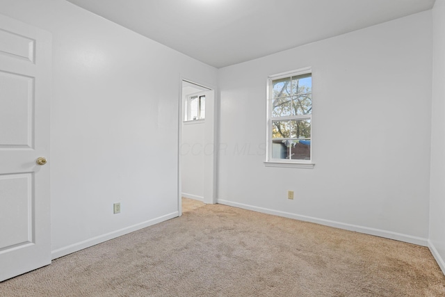 spare room with light carpet