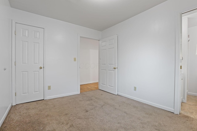 unfurnished bedroom featuring light colored carpet