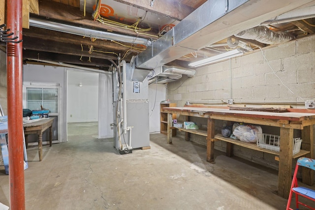 basement with a workshop area and heating unit