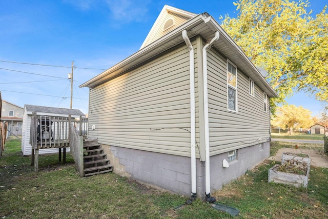 view of property exterior with a yard and a deck