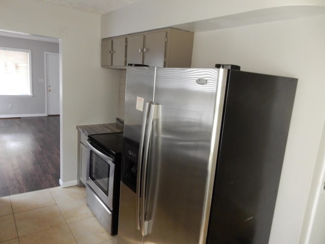 1447 Republic Ave, Columbus, OH 43211 - kitchen with gray cabinetry, stainless steel appliances, a textured ceiling, and light wood-type flooring