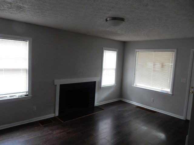 1447 Republic Ave, Columbus, OH 43211 - unfurnished living room featuring a textured ceiling and dark wood-type flooring