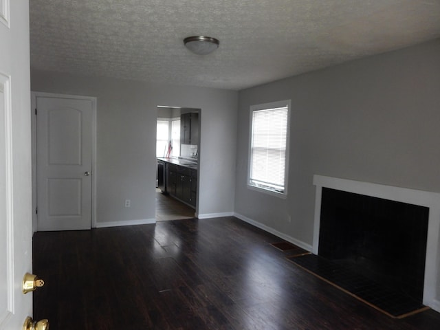 1447 Republic Ave, Columbus, OH 43211 - unfurnished living room featuring dark hardwood / wood-style flooring and a textured ceiling