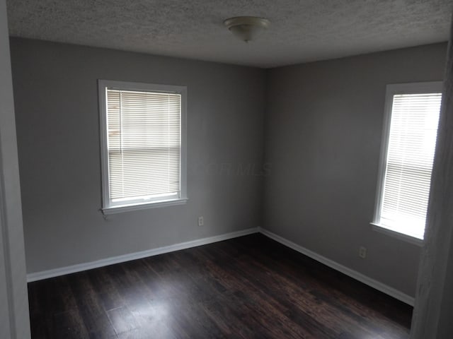 1447 Republic Ave, Columbus, OH 43211 - spare room featuring a textured ceiling and dark hardwood / wood-style floors