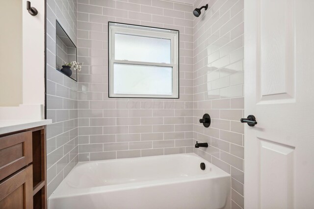 bathroom featuring vanity and tiled shower / bath combo