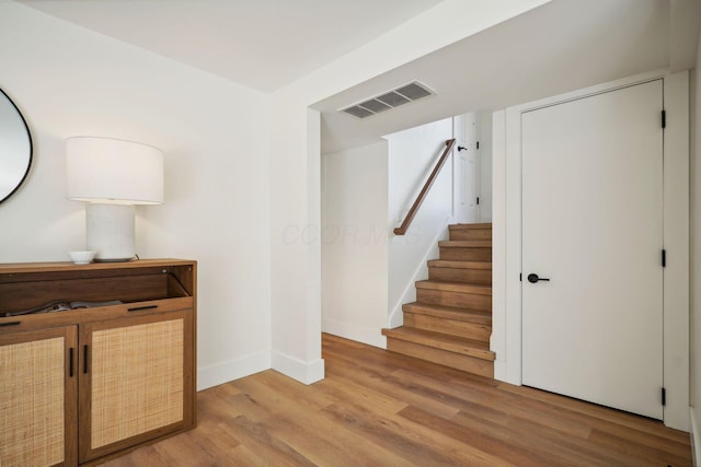 staircase with hardwood / wood-style flooring