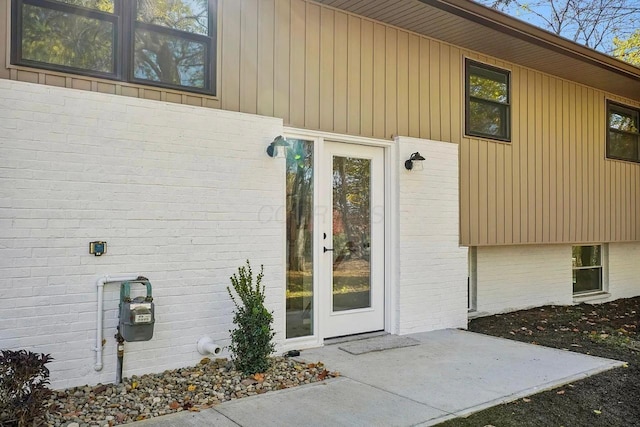 view of exterior entry featuring a patio area