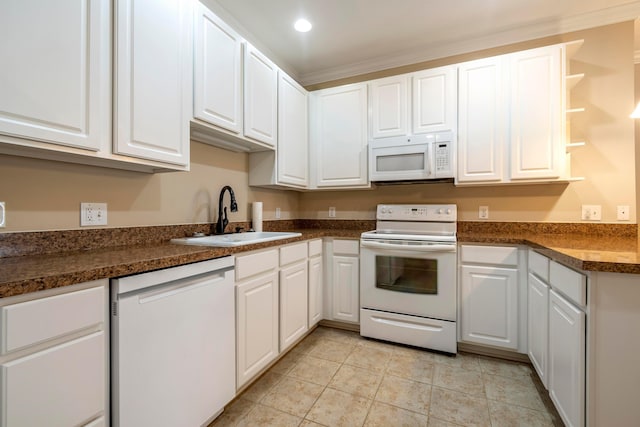 kitchen with white appliances, white cabinets, sink, ornamental molding, and light tile patterned flooring