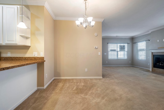 interior space with a tile fireplace, light colored carpet, an inviting chandelier, and crown molding