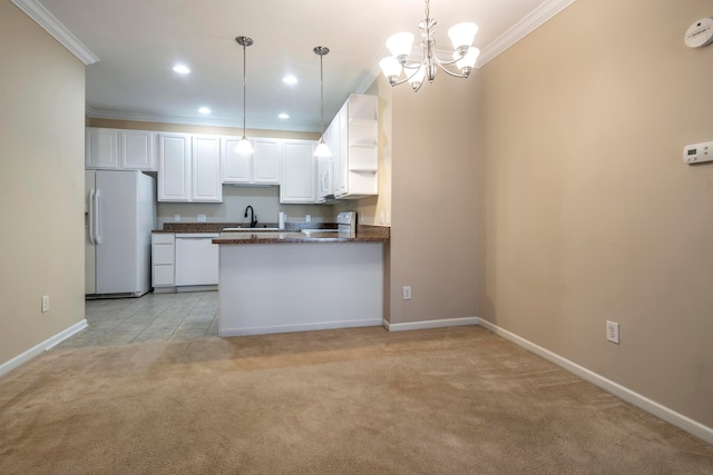 kitchen with white cabinetry, sink, hanging light fixtures, kitchen peninsula, and white appliances