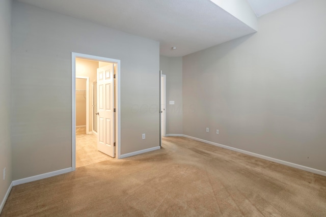 unfurnished bedroom featuring light carpet