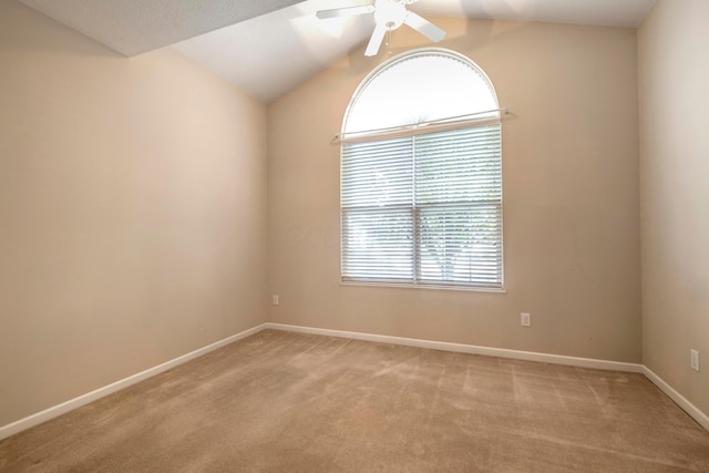 carpeted empty room with ceiling fan and vaulted ceiling