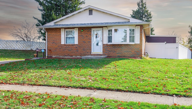 bungalow-style house with a lawn