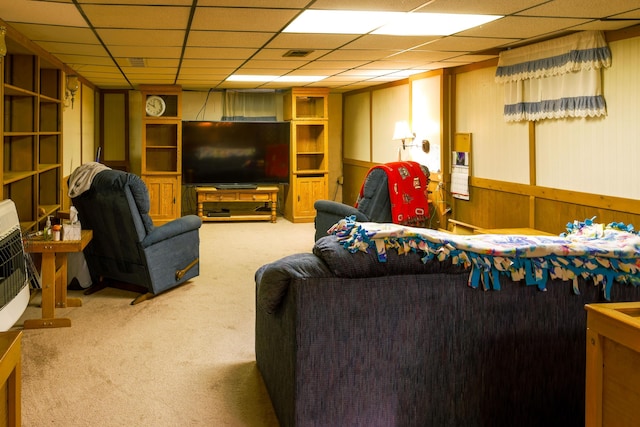 carpeted living room with a paneled ceiling