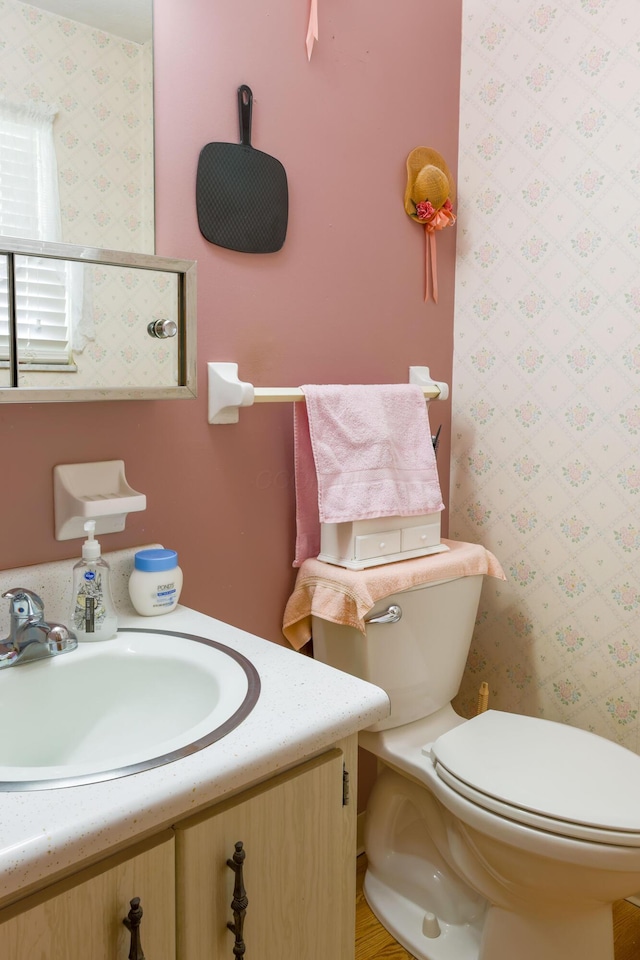 bathroom featuring vanity and toilet