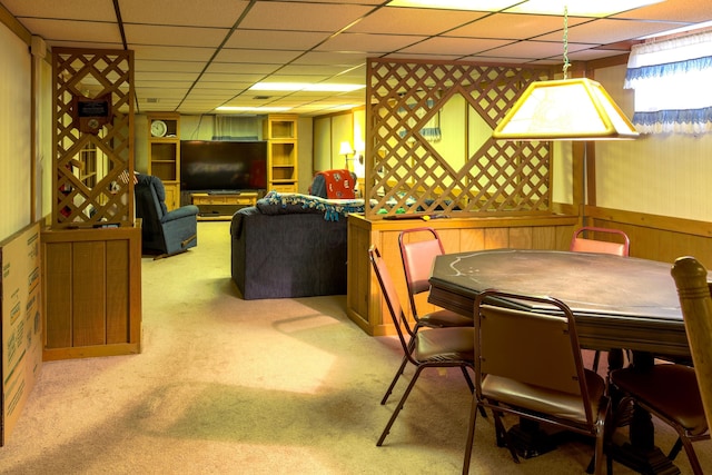 carpeted dining area featuring a drop ceiling