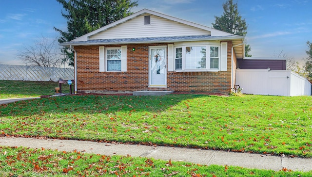 bungalow-style home featuring a front yard