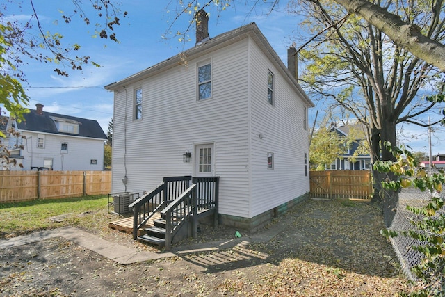 back of property featuring central air condition unit