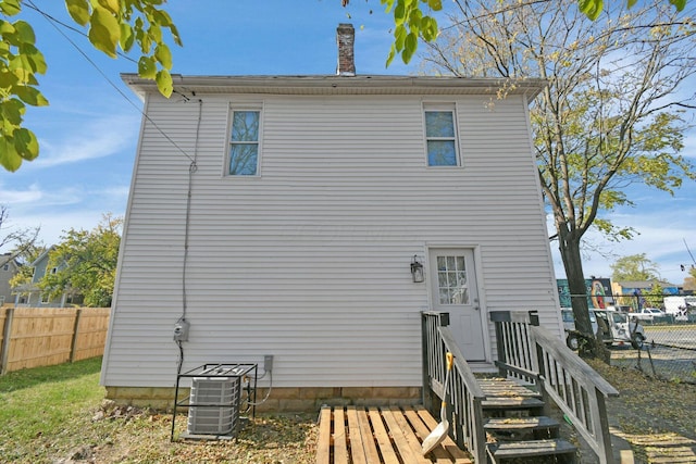 rear view of house with central air condition unit