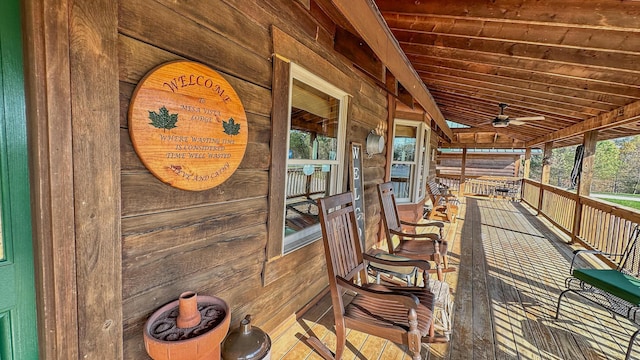 deck featuring covered porch and ceiling fan