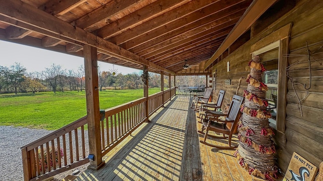 wooden terrace with a yard and ceiling fan