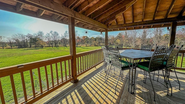 wooden terrace featuring a lawn