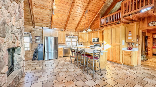 kitchen featuring appliances with stainless steel finishes, high vaulted ceiling, a healthy amount of sunlight, and wood ceiling