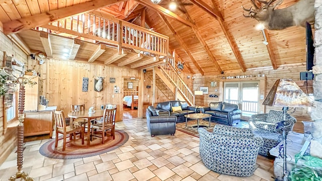 living room featuring vaulted ceiling with beams, wood ceiling, and wooden walls