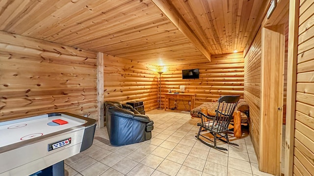 living area with rustic walls, wooden ceiling, and light tile patterned flooring