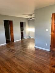 unfurnished room featuring ceiling fan and dark hardwood / wood-style floors